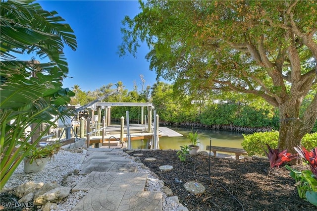 view of yard featuring a dock and a water view