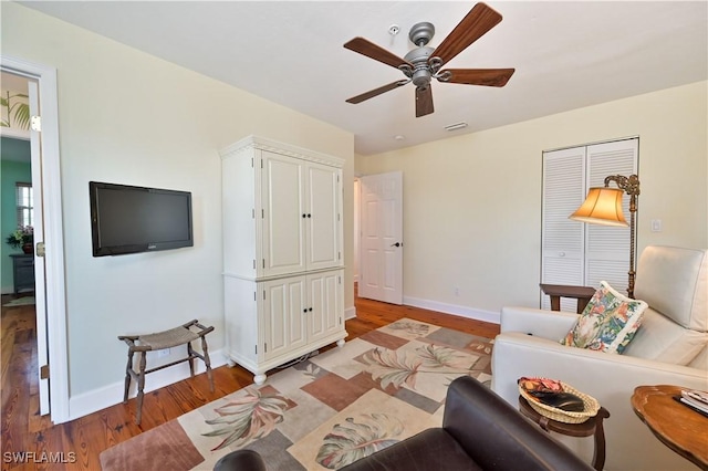 living room with ceiling fan and light hardwood / wood-style flooring