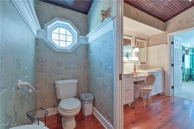 bathroom featuring toilet, hardwood / wood-style floors, and ornamental molding