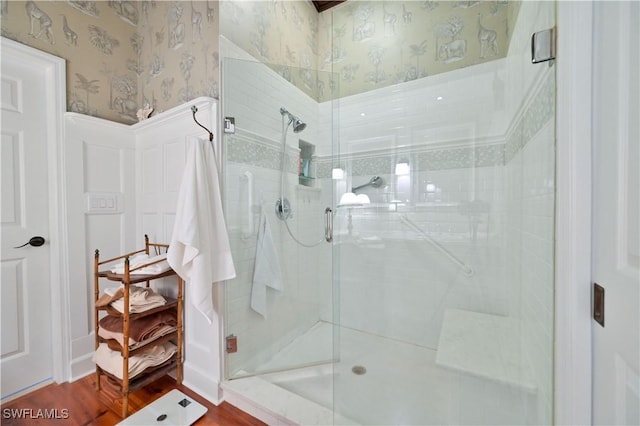 bathroom with an enclosed shower and hardwood / wood-style flooring