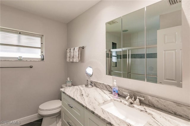 bathroom with toilet, an enclosed shower, vanity, and tile patterned floors