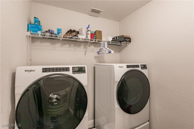 clothes washing area featuring washing machine and clothes dryer