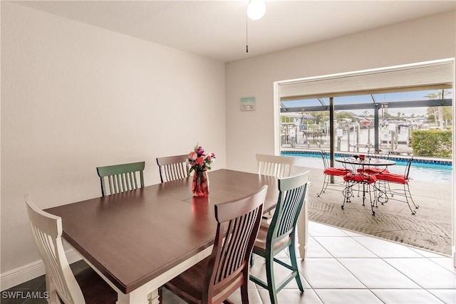 dining space featuring light tile patterned flooring