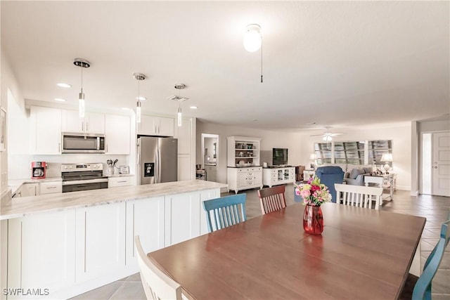 tiled dining area featuring ceiling fan