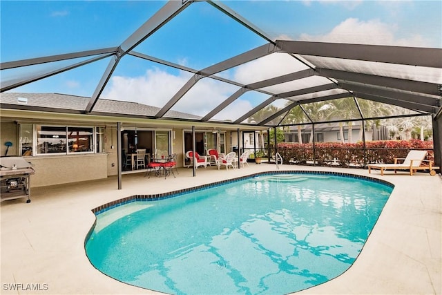 view of pool featuring a lanai and a patio