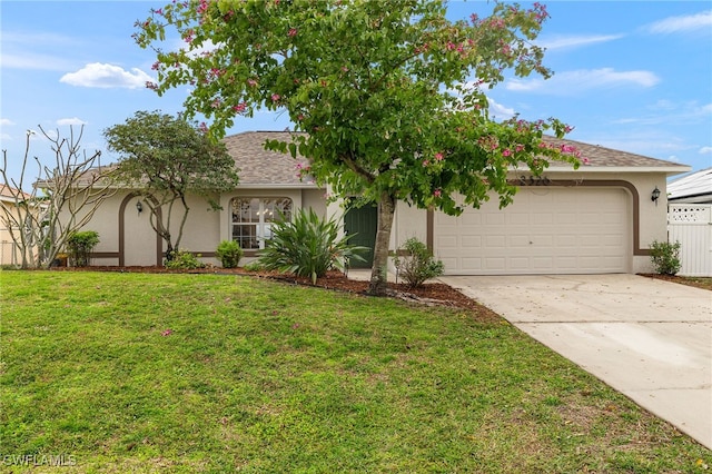 view of front of property featuring a garage and a front lawn