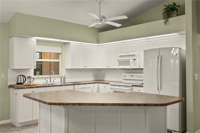 kitchen with white cabinetry, white appliances, sink, and a kitchen island