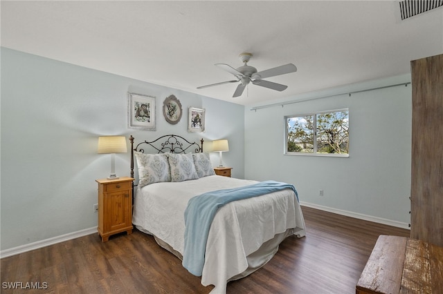 bedroom with dark hardwood / wood-style flooring and ceiling fan