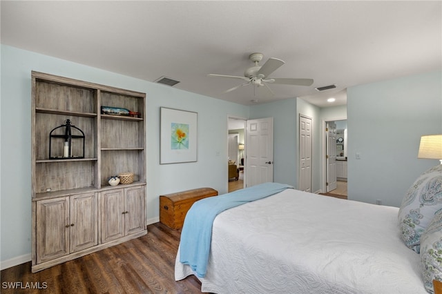 bedroom featuring ceiling fan, ensuite bathroom, dark hardwood / wood-style flooring, and a closet