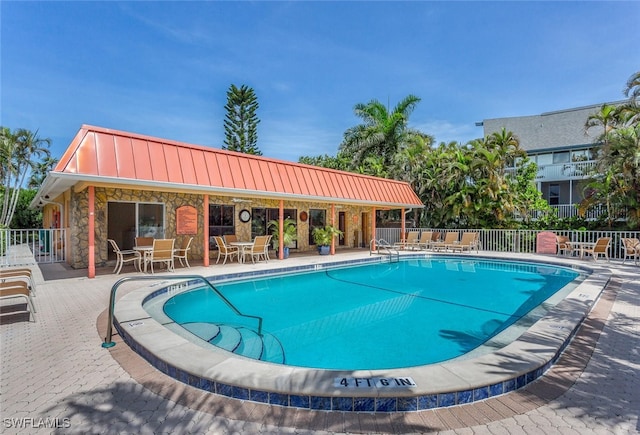 view of swimming pool with a patio