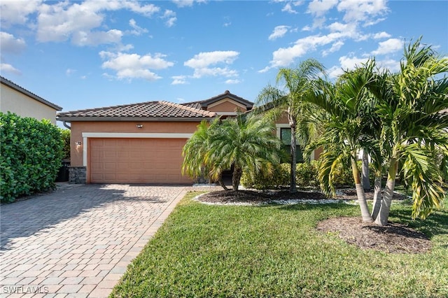 view of front of property with a garage and a front yard