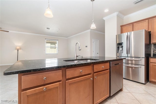 kitchen featuring appliances with stainless steel finishes, an island with sink, ornamental molding, and sink