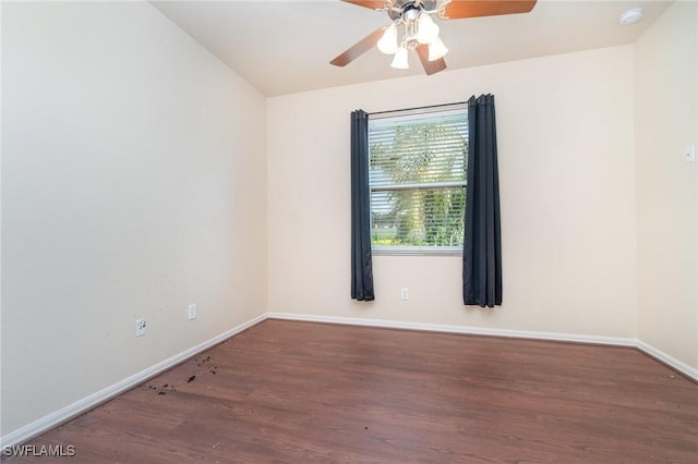 spare room featuring dark hardwood / wood-style flooring and ceiling fan