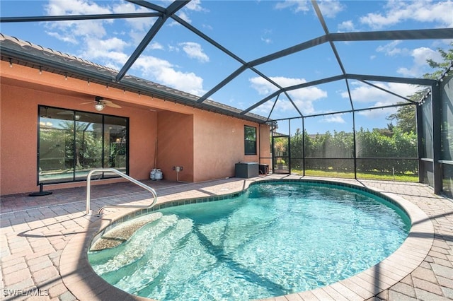 view of pool featuring a lanai, a patio area, and ceiling fan