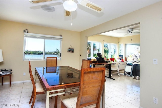 tiled dining area featuring ceiling fan and a healthy amount of sunlight