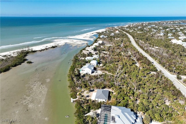 drone / aerial view featuring a beach view and a water view