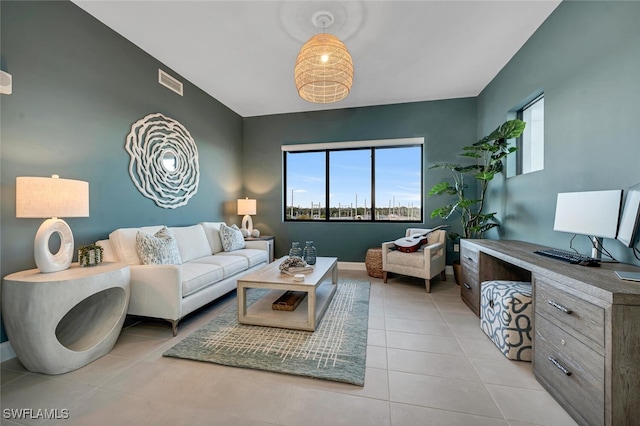 living room with vaulted ceiling and light tile patterned floors