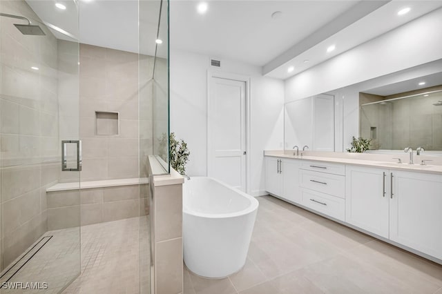 bathroom with vanity and shower with separate bathtub