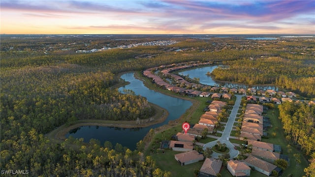 aerial view at dusk with a water view