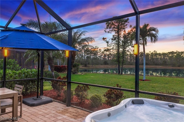 sunroom featuring a jacuzzi and a water view