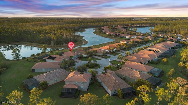 aerial view at dusk with a water view