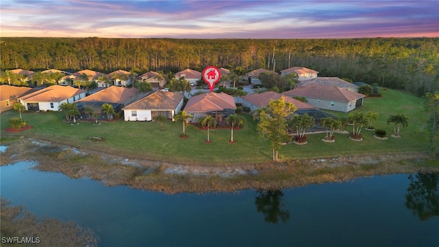 aerial view at dusk with a water view