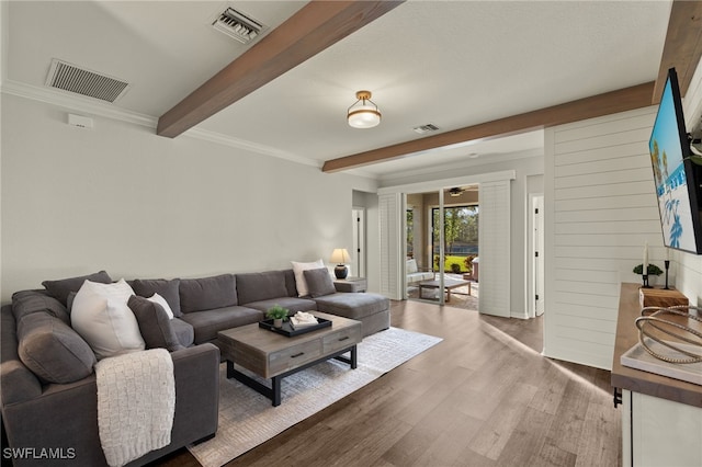 living room with hardwood / wood-style floors and beamed ceiling