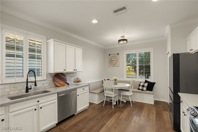 kitchen featuring breakfast area, stainless steel appliances, white cabinetry, and sink