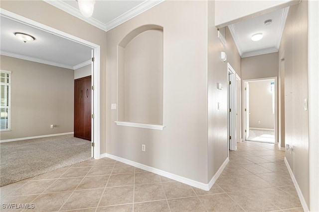 hallway featuring crown molding and light tile patterned floors