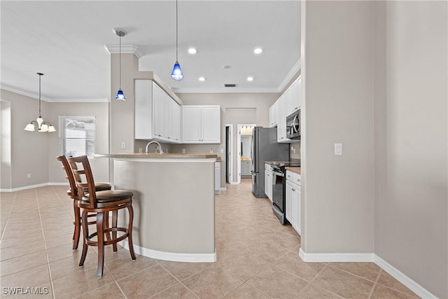 kitchen with ornamental molding, stainless steel appliances, a chandelier, and white cabinets