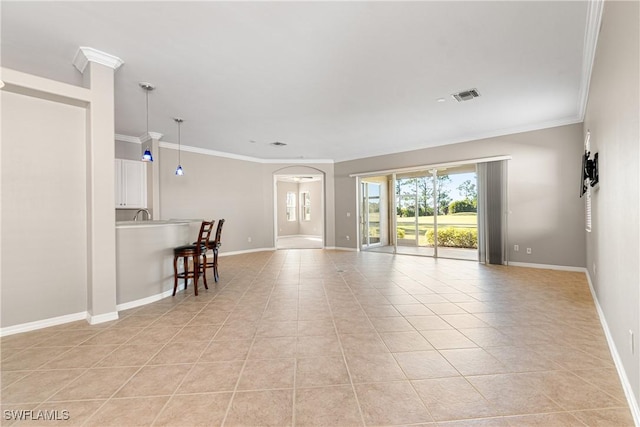 unfurnished living room with crown molding and light tile patterned floors