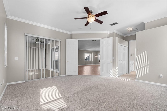 carpeted empty room featuring crown molding and ceiling fan with notable chandelier