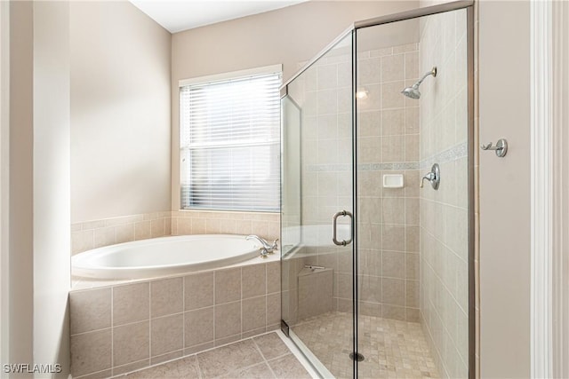 bathroom featuring tile patterned flooring and independent shower and bath