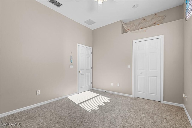 unfurnished bedroom with ceiling fan, a closet, and carpet