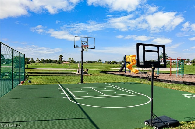 view of basketball court featuring a yard and a playground