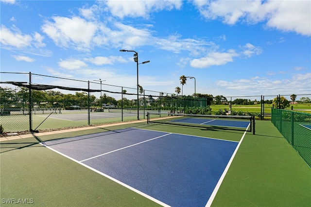 view of tennis court featuring basketball court