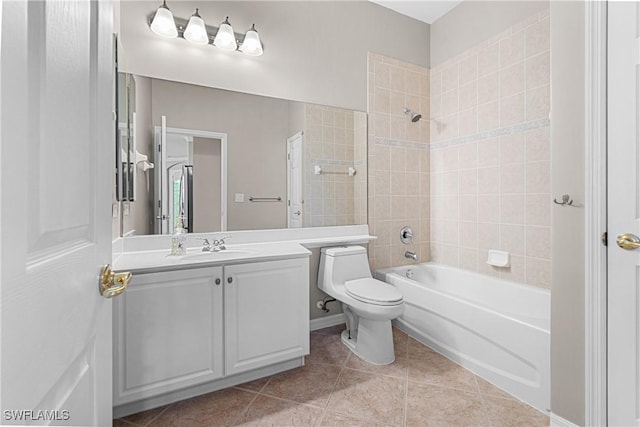 full bathroom featuring tiled shower / bath, toilet, tile patterned floors, and vanity