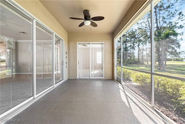 unfurnished sunroom featuring ceiling fan