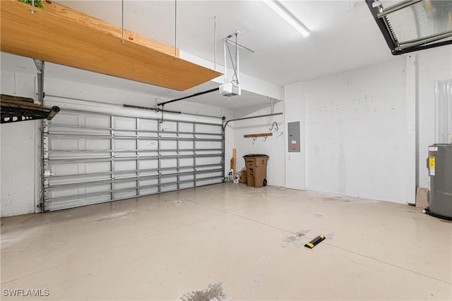 garage featuring a garage door opener, electric panel, and electric water heater