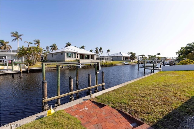 dock area featuring a yard and a water view