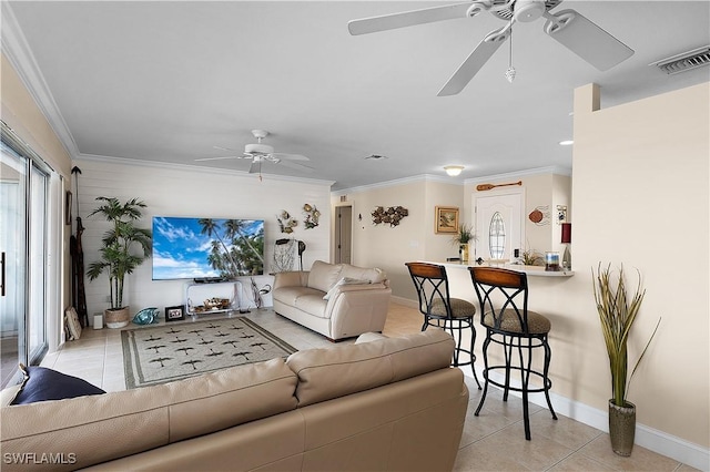 living room with crown molding and light tile patterned flooring