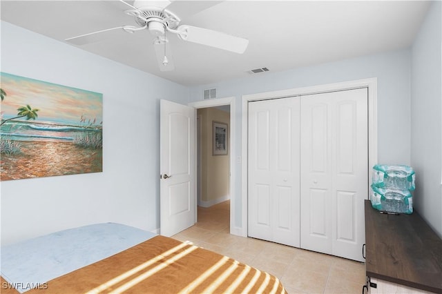 tiled bedroom with a closet and ceiling fan