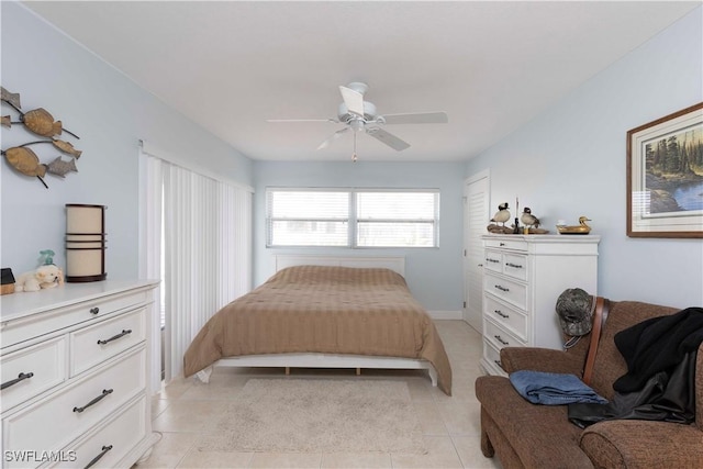 tiled bedroom featuring ceiling fan