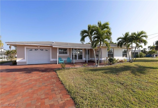 ranch-style home with a front yard and a garage