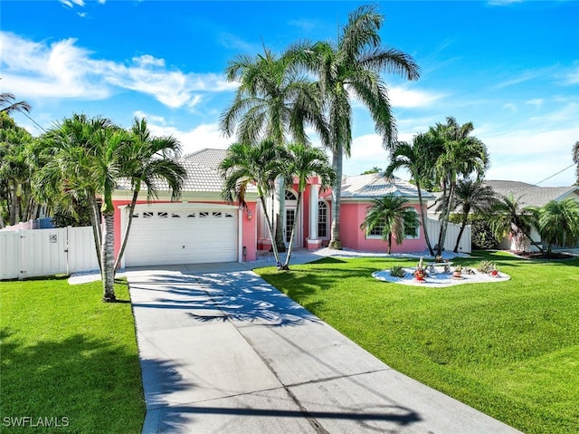 view of front facade featuring concrete driveway, a front lawn, fence, and a gate