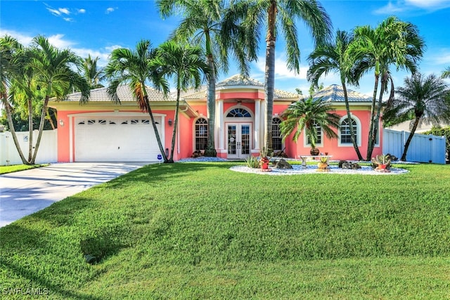 view of front of home with a garage, fence, concrete driveway, french doors, and stucco siding