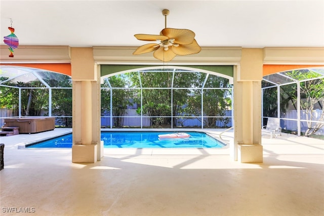 pool featuring a lanai, a patio area, ceiling fan, and a hot tub