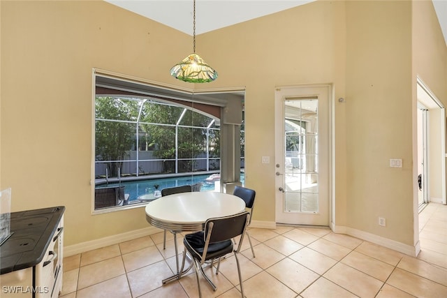 dining room with a sunroom, baseboards, and light tile patterned floors