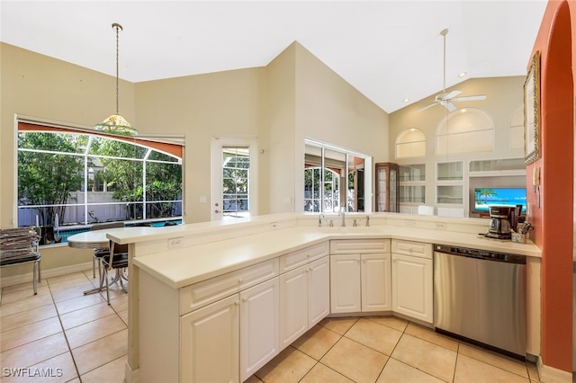 2616 SW 52nd St, Cape Coral, FL 33914 - kitchen with stainless steel dishwasher, light tile patterned floors, high vaulted ceiling, and healthy amount of natural light