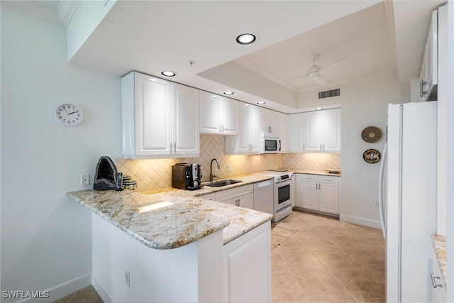 kitchen with kitchen peninsula, range with electric cooktop, sink, white cabinets, and white fridge